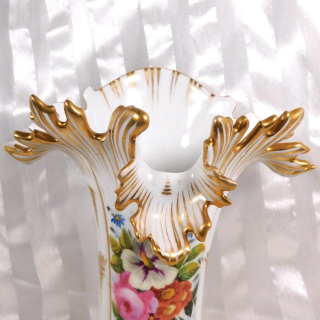 This is a white porcelain unmarked vase with a lot of gold trim. The base is only marked 41. It has pink, yellow and...