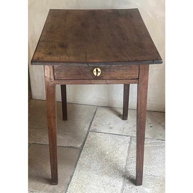 Late 18th-century side from the English Georgian period. A rustic, provincial design typical of country-made furniture...