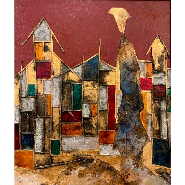 A hillside village emerges from a ground of gold leaf, its rooftops and walls suggested in terracotta and olive green that...