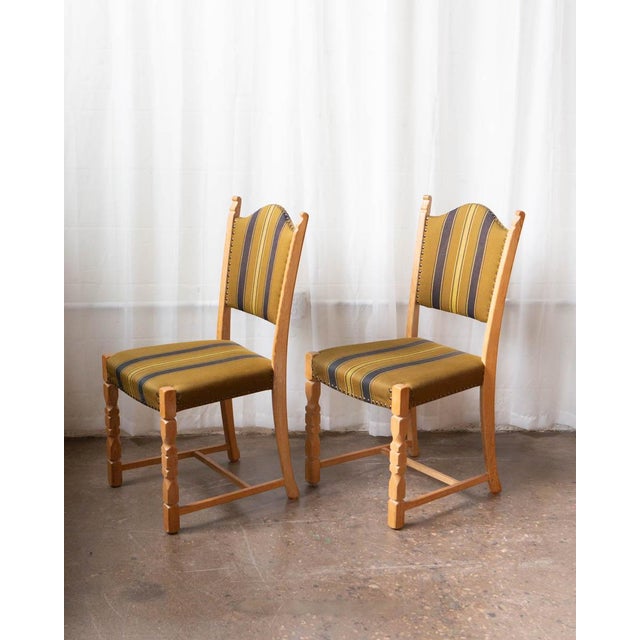A beautifully composed set of six Danish dining chairs from the 1970s, executed in the style of Henning Kjærnulf. Solid...