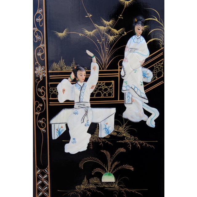 A beautiful set of four vintage Chinese decorative wall panels crafted in black lacquer with intricate mother-of-pearl...