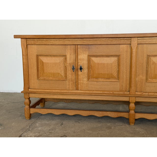 This oak sideboard was designed by Henning Kjærnulf and produced by Nyrup Møbelfabrik in Denmark during the 1960s. Four...