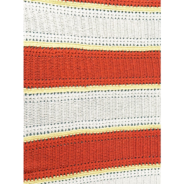 Beautiful vintage handmade crochet afghan featuring bold alternating stripes of warm rust orange and oatmeal cream,...