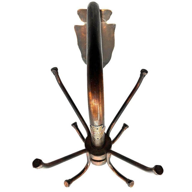 A rare early 20th century industrial wall-mounted Japanned (copper flashed) “Wall Tree” coat rack manufactured by Peedee’s...