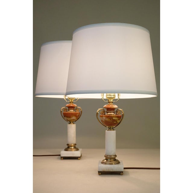 A sophisticated and elegant perfectly matched pair of White & Salmon Onyx Marble Bronze/Brass Art Deco Neo Classic...