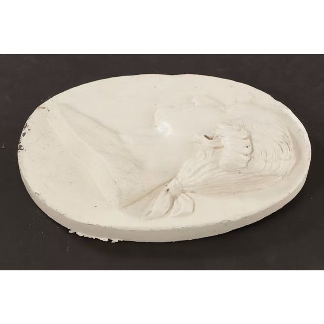This exceptional 19th-century neoclassical relief plaque features a beautifully carved profile portrait of a classical...