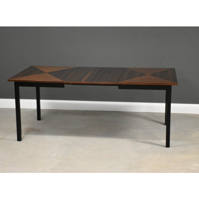 A mid century modern walnut dining table with three 12” leaves which fully expand the table to 86”. Professionally...