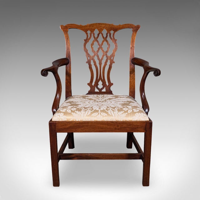 This is an antique Gentleman's Elbow chair. An English, mahogany desk or morning room seat in Chippendale taste, dating to...