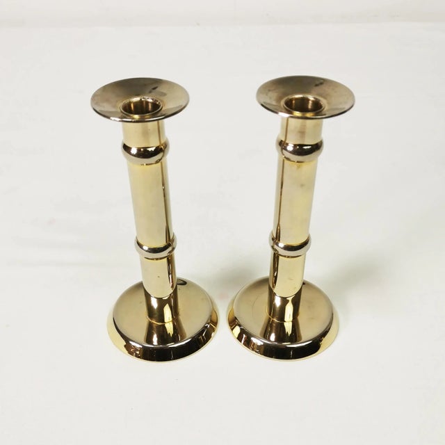 Pair of candlesticks, produced in Denmark, 1960s (signature). They are characterized by a sparing form. Made of brass -...