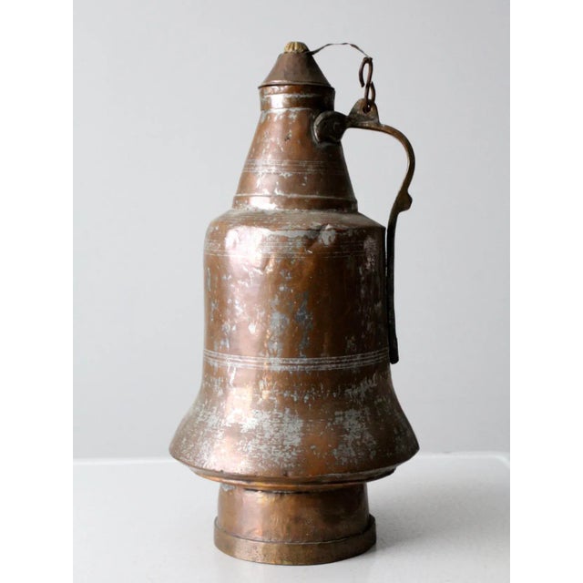 Antique copper jug featuring a warm, aged patina and classic hand-crafted form. This beautiful copper vessel includes a...