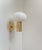 An elegantly crafted wall sconce in brass featuring a mushroom shaped white opaline glass shade. Unknow Scandinavian...