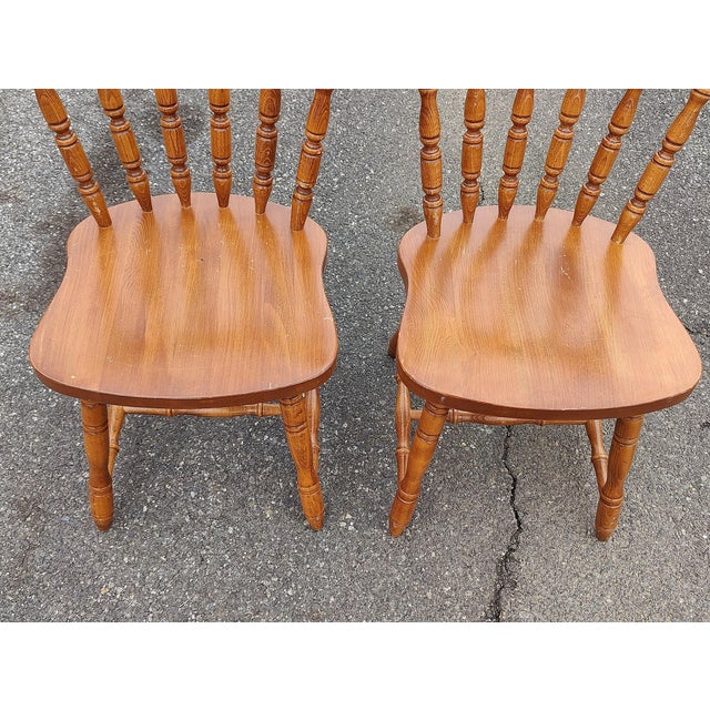 This is a beautiful set of two antique Windsor style dining chairs. These classic farmhouse chairs have turned spindle...