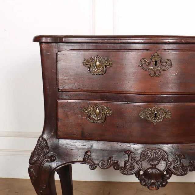 Pretty 18th century Portuguese commode crafted from mahogany and teak, showcasing a serpentine front design with two...