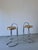A set of two vintage bar stools featuring tubular chrome frames and round cane seats. Condition: good vintage condition...