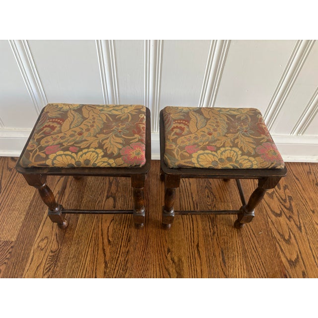 Lovely par of traditional English petite footstools in dark woods with muted color tapestry upholstery. Rather primitive...