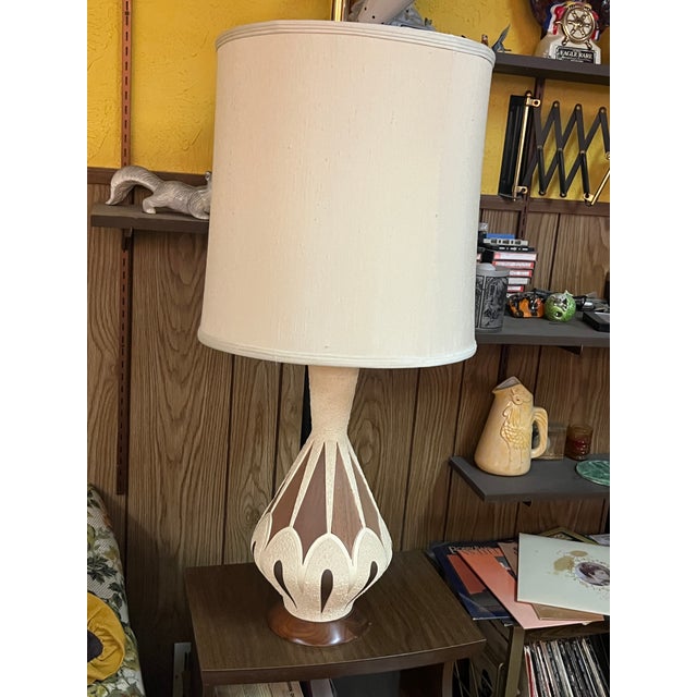 An exceptional and rare matching pair of mid-century modern atomic-era table lamps, circa 1960. These sculptural statement...