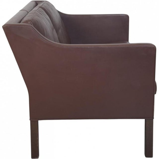 Børge Mogensen 2422 2.seater sofa upholstered in brown leather, and with legs of stained oak. The sofa is from the 1980s...