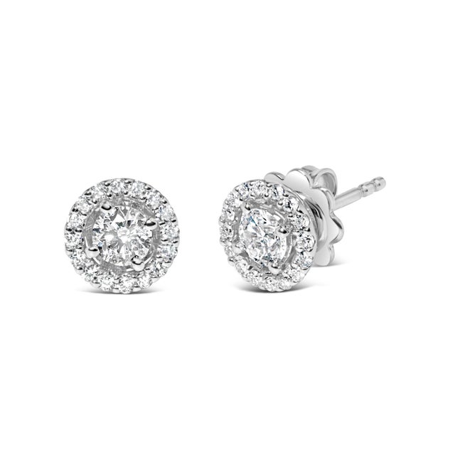 Elevate your elegance with these enchanting stud earrings, a masterpiece in 14K white gold. Immerse yourself in the...