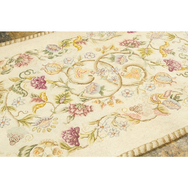 Handmade in wool, this 4x7 antique Canadian hooked rug originating circa 1920-1929 is a delightful expression of North...