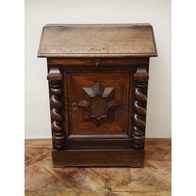 The solid oak chest of drawers with a secretary extension represents high-quality craftsmanship from the Baroque period....