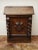 The solid oak chest of drawers with a secretary extension represents high-quality craftsmanship from the Baroque period....