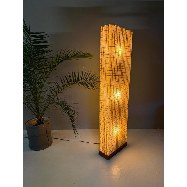 Handcrafted Sculptural Floor Lamp This tall handcrafted floor lamp is a striking blend of materials and soft, ambient...