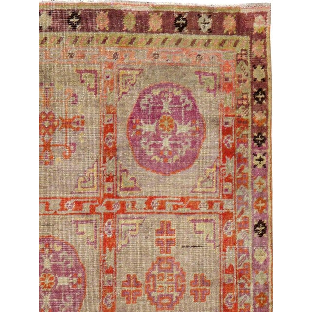 An antique Khotan carpet from the first quarter of the 20th century. Khotan rugs and carpets were produced in the oasis...