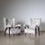 Pair of Italian lounge chairs with trapezoidal, large backrests and upholstered armrests. The armchairs stand on tapered,...