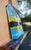 This artwork features a vibrant depiction of a lake scene in Cherokee, Florida, where a striking leaf motif emerges...