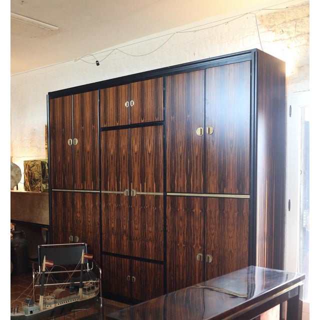 Discover this extraordinary Macassar ebony wardrobe, a rare and imposing piece enhanced by elegant brass details. Designed...