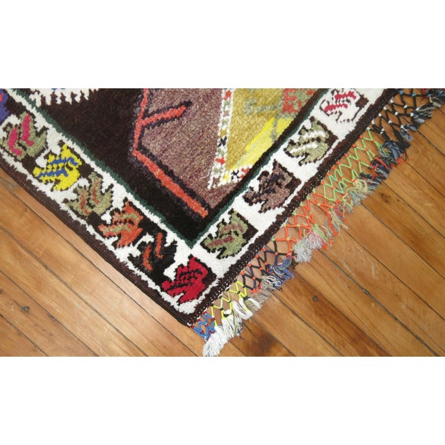 One of a kind, mid 20th-century Hand-knotted Turkish Wool Runner with multiple colorful medallions on a brown field....