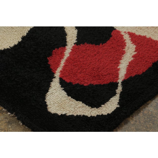This 5x6 mid-century modern rug, crafted in wool, presents a contemporary interpretation of the movement's expressive...