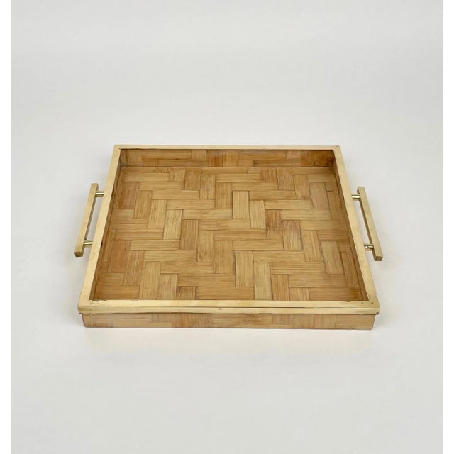 Squared serving tray in rattan featuring brass borders and handles attributed to Tommaso Barbi. Made in Italy in the 1970s.
