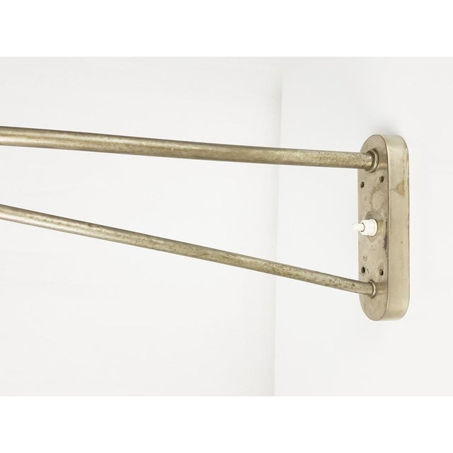 This large wall lamp was produced in Italy between the 1940s and 1950s. It features a nickel-plated tubolar frame with an...