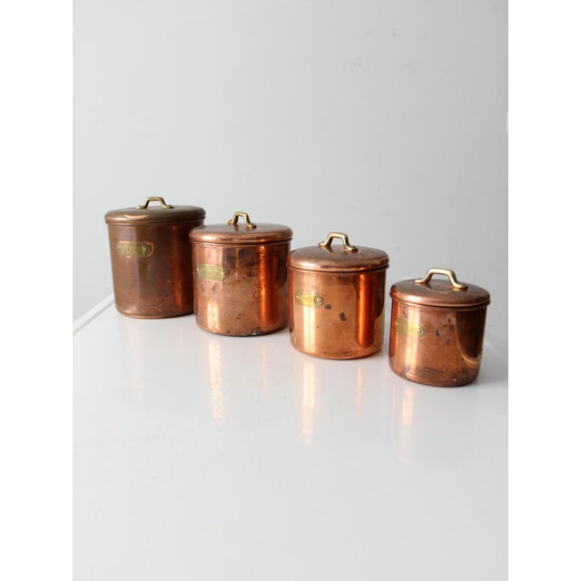Add a touch of timeless elegance to your kitchen with this vintage copper canister set. Featuring a beautiful patina,...