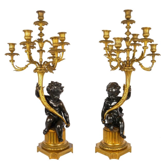 A VERY FINE PAIR OPPOSING PUTTO FIGURALS RAISING CORNUCOPIA WITH SEVEN-LIGHT CANDELABRA Paris, circa 1880 Gilded bronze,...