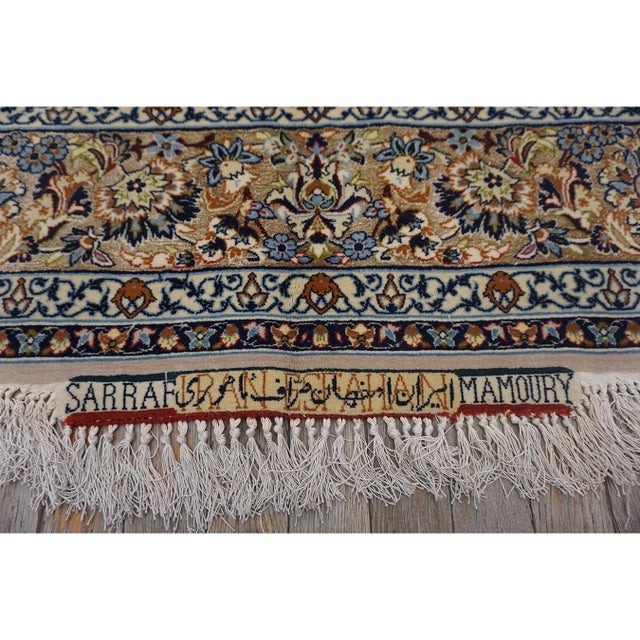 A 1940s vintage Isfahan rug attributed to the master weaver Sarraf Mamoury, measuring approximately 5’0″ × 8’0″. The...