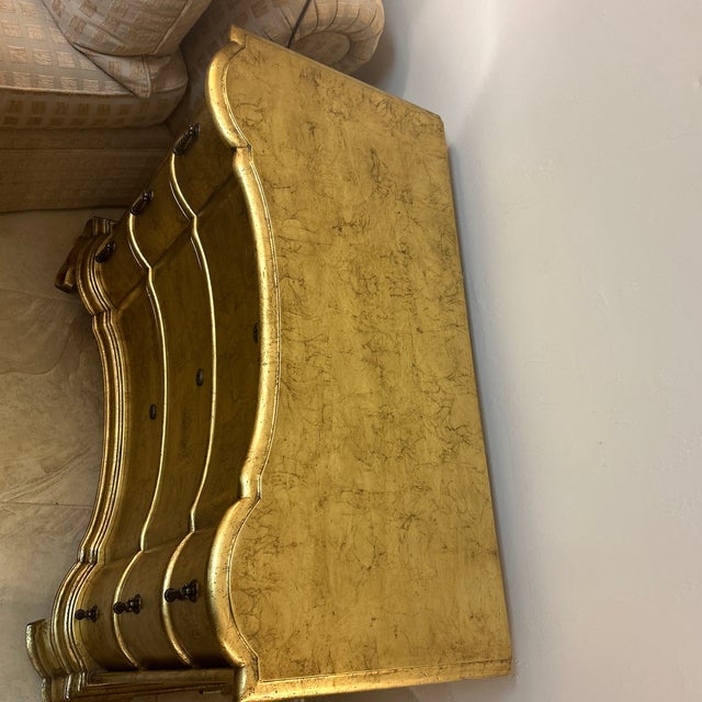 Gorgeous glimmering chest of drawers. Serpentine silhouette drawer fronts. Entirety of chest is covered in bronzed gold...