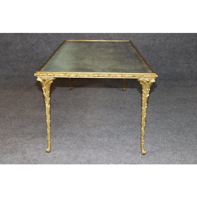 This elegant Maison Baguès églomisé glass coffee table is a superb example of twentieth-century French luxury design,...