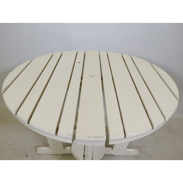 Folding table "Riviera" by Triconfort, France, with a round, slatted tabletop made of white lacquered wood. Functional,...