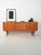 Swedish teak sideboard with original label, tiled central drawers, and sliding side doors. "Trio" sideboard designed by...