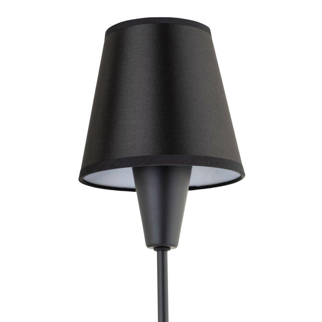 Elegant, tapered shades in matte black or rattan provide warmth and enhance the clean lines and refined polished brass...