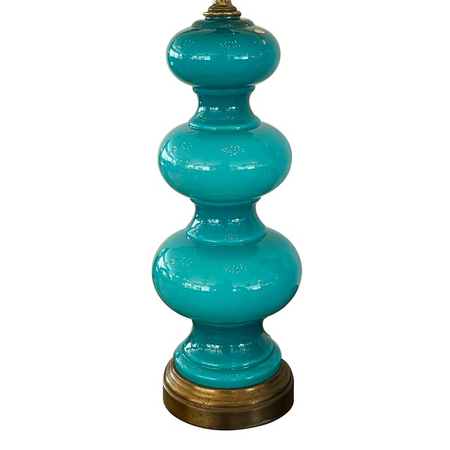 the French made cased-glass bodies of graduated triple-gourd form resting on brass bases; in a deep teal color accentuated...