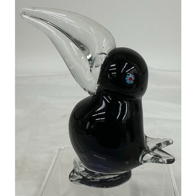 Cute hand blown bird figurine. Very dark blue body, clear glass beak, tail and feet, millefiori eyes.