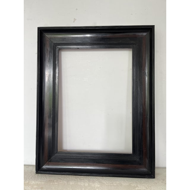 Elegant antique ebonized wooden picture frame featuring a deep black ebony-style finish with warm undertones and refined...