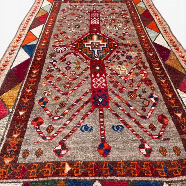 This distinctive antique Qashqai rug, handknotted over 100 years ago, showcases an exceptional and highly stylized...