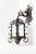 Crafted from heavy-gauge hand-forged wrought iron, this sconce features a dramatic architectural silhouette characterized...
