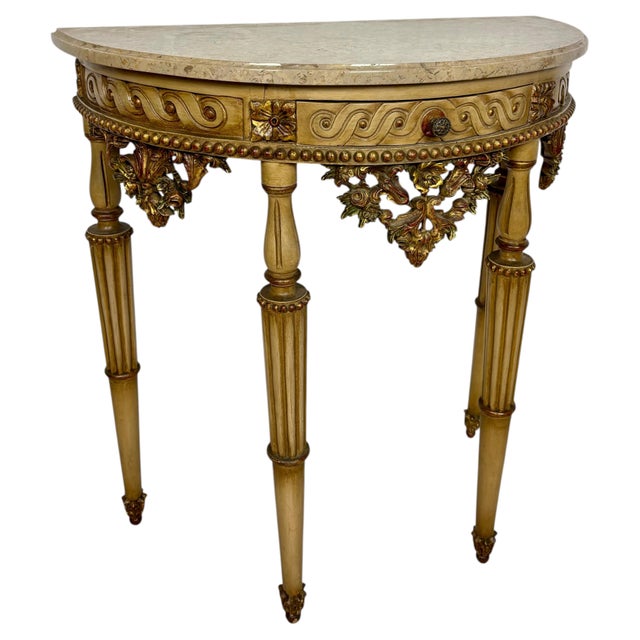 Elegant Italian demi-lune console table crafted in carved polychromed wood and topped with a shaped marble surface. Raised...