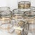 A striking set of eight vintage lowball glasses featuring crisp horizontal gold banding on clear glass, embodying the...