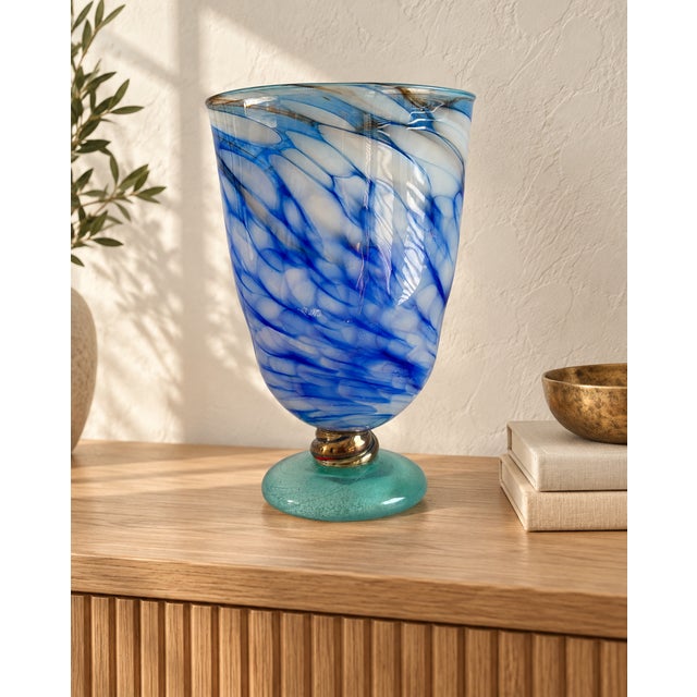 Flowing cobalt-blue and milky-white swirls give this footed glass vase a striking sense of movement. The elongated body...
